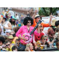 732_0075 Mann mit Hemd in pink und Afro-Look-Perücke  spielt auf einer Plastikguitarre. | Schlagermove Hamburg - Ein Festival der Liebe.